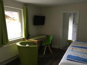 a hotel room with a desk and a bed and a window at Haus Schwarzenberg in Ernst