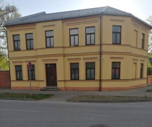a yellow building on the side of a street at Villa Ventus in Liepāja