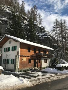 a house with snow on the side of a mountain at Chalet 12 Cerfs in Evolène
