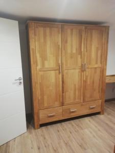 a large wooden cabinet in a room at Emmerich s neu errichtete DG-Wohnung in Bad Wildungen