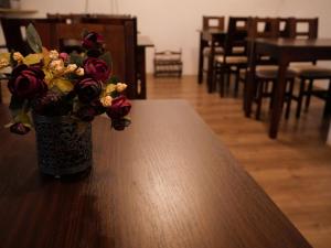 a vase of flowers sitting on top of a table at Pokoje Szczawnica Centrum - duży ogród in Szczawnica +25 photos