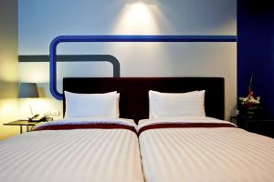 Postel nebo postele na pokoji v ubytování FX Hotel Metrolink Makkasan + 18 fotografií