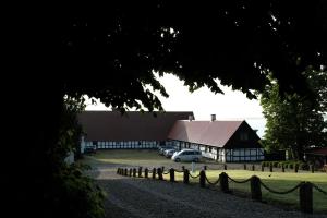 a barn with a car parked in front of it at Skibstedgaard in Hurup