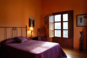 a bedroom with a bed and a window and a door at Casa de Aldea La Llosa in Ribadedeva