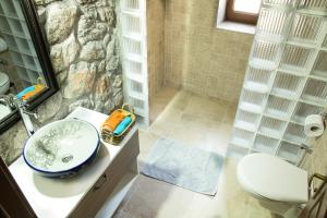 a bathroom with a sink and a shower at Doga Apartments in Kayakoy