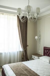a bedroom with a bed and a large window at Old Town River Apartments in Klaipėda