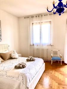a bedroom with a large bed and a blue chandelier at B&B la Serenissima in Fossalta di Portogruaro