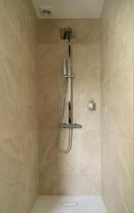 a bathroom with a shower with a shower head at Chambre d'Hôtes chez Artiste Verrier, La Perrière - Perche in La Perrière