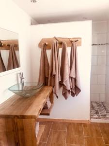 a bathroom with a glass sink and towels at Le Nid Montagnard in Aucun +59 photos
