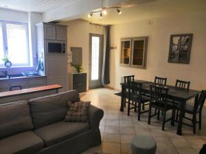 a living room with a couch and a table and chairs at La Casa de Brens in Brens