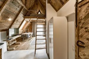 a ladder leading up to a loft office with a desk at HEL in Zakopane
