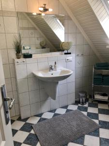 a bathroom with a sink and a mirror at Appartements Friedrichsen in List +39 photos