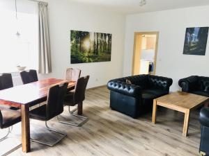 a living room with a table and a couch at Holiday home in Brilon near the ski slopes in Brilon