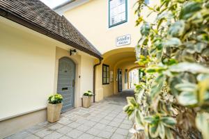 a hallway of a building with a door and plants at Haus im Schlossergässchen in Baden