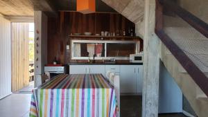 una cucina con tavolo e una tovaglia colorata di Ammunaini a Punta Del Diablo