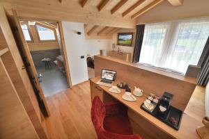 a room with a desk with a laptop on it at Roberta Loft - rooms and apartments in Livigno