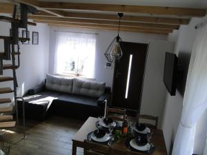 a living room with a couch and a table at Domek Antonówka in Szklarska Poręba