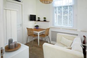 a living room with a table and a couch at Guest House Aquarius in Zandvoort