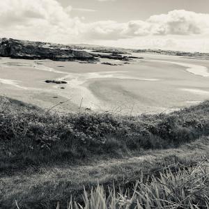 a black and white photo of a beach at Village Way Apartments in Kincasslagh