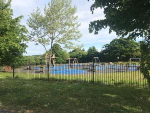 a playground behind a fence in a park at Chase Heights in Rugeley