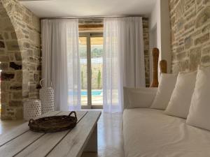 a living room with a white couch and a table at LAINI LUXURY SUITES in Pómbia +157 photos