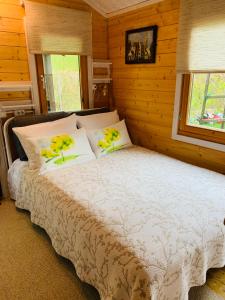 a bedroom with a bed with yellow flowers on it at Vila Renata Laure in Palanga