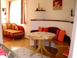 a living room with a table and a chair at FeWo Wassertheurer in Tröpolach
