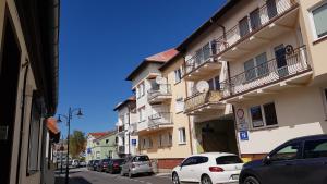 a city street with cars parked in front of buildings at Mieszkanie Nad Morzem in Ustka