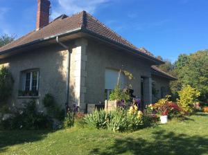 a small house with flowers in the yard at Chez madame loic in Fère-Champenoise