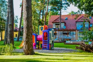 a playground in a yard in front of a house at Ośrodek Vega in Pobierowo