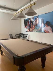 un tavolo da biliardo in una stanza con una foto sulla parete di HI Tavira – Pousada de Juventude a Tavira
