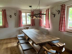 a dining room with a wooden table and chairs at Villgratenhaus in Außervillgraten