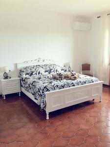 a dog laying on a bed in a bedroom at Villa Sofia in Pramaggiore