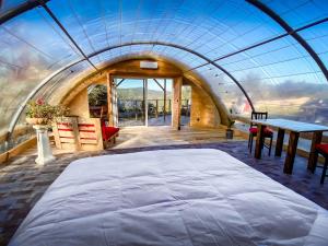 a bedroom with a large bed and a table at Les insolites de Taracopala in Solliès-Toucas