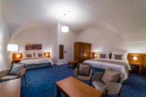 Postel nebo postele na pokoji v ubytování Hotel Panský Pivovar
