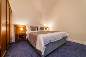 Postel nebo postele na pokoji v ubytování Hotel Panský Pivovar