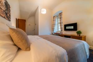 Postel nebo postele na pokoji v ubytování Hotel Panský Pivovar