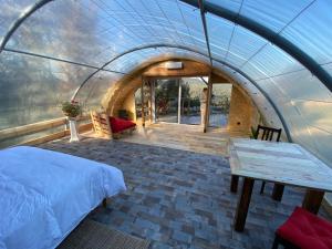 a bedroom in a dome tent with a bed and a table at Les insolites de Taracopala in Solliès-Toucas