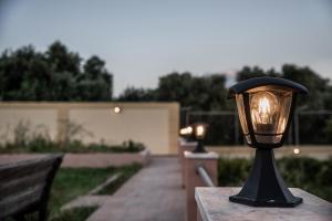 a black lamp on a table with a pathway at La Siesta in Marathi