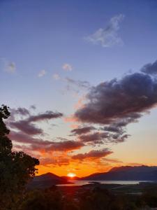 a sunset with the sun setting in the sky at Apartment Jelena Sutvara in Kotor