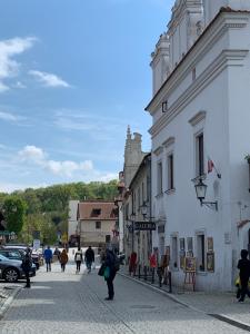a group of people walking down a city street at Kamienica Biała in Kazimierz Dolny