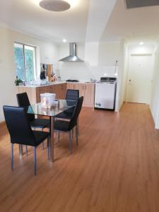 a kitchen and dining room with a table and chairs at BHA in Perth