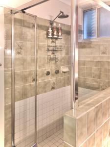 a bathroom with a shower with tiled walls at Eden Rest in Cooroy