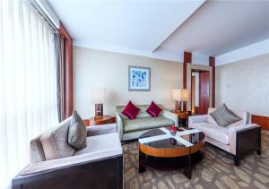 a living room with a couch and a table at Beijing Kuntai Royal Hotel in Beijing +32 photos
