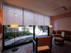 a living room with a large fish tank in a window at Hotel Intergate Kyoto Shijo Shinmachi in Kyoto