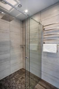 a bathroom with a shower with a glass door at Riga Centre Apartment in Riga