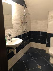 a bathroom with a sink and a toilet at Anfid Apartments in Burgas