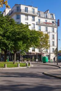 a large white building on the side of a street at Hôtel de la Place des Alpes in Paris