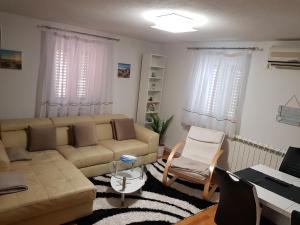 a living room with a couch and a table at Apartment Prima in Koper
