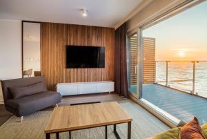 salon z kanapą i stołem w obiekcie Apartos Sailor - Luxury Apartments w mieście Ustronie Morskie